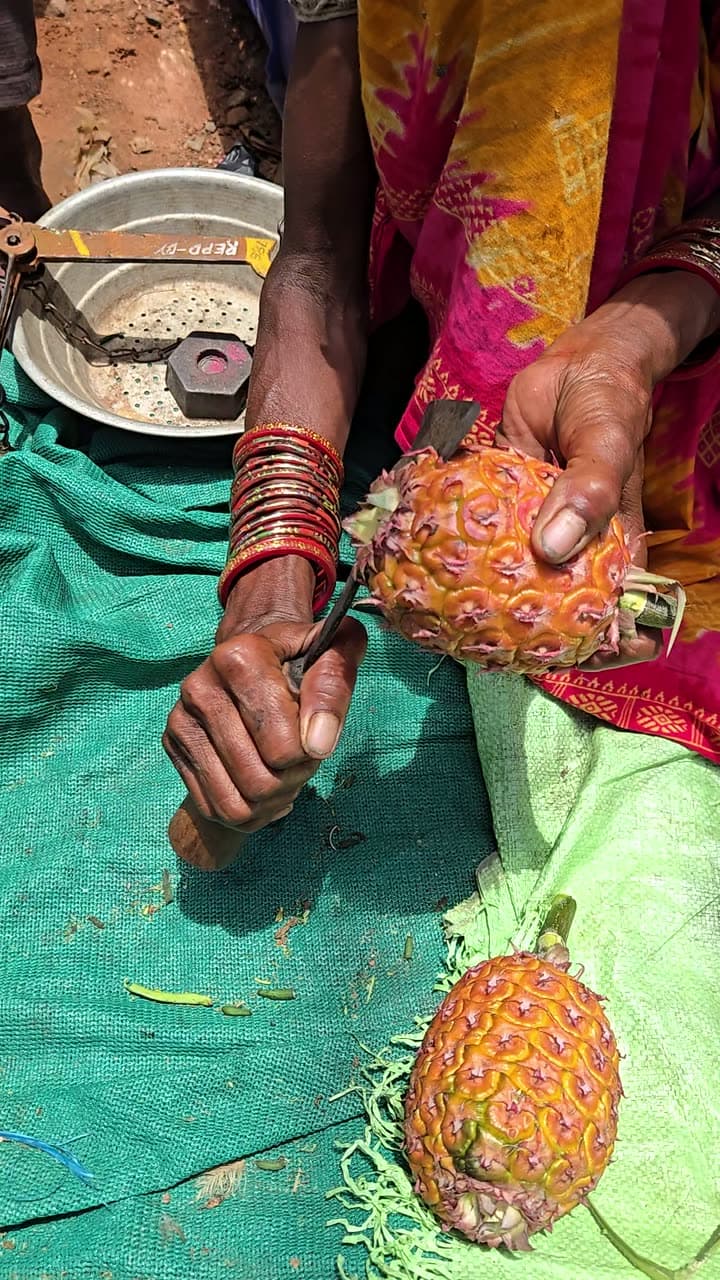 A producer holding freshly harvested native produce in her hands