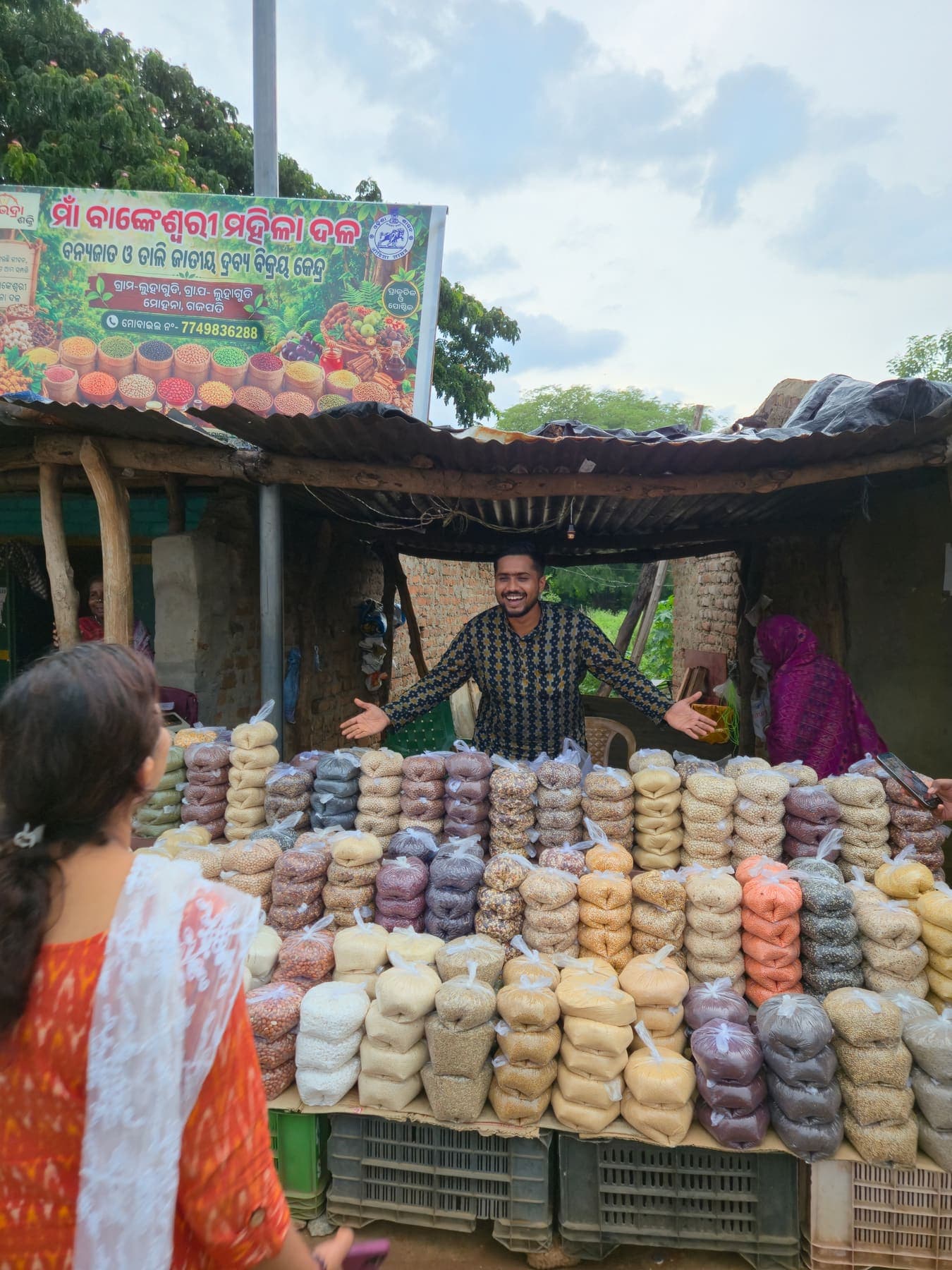 A producer collective market stall with its programme banner and graded produce packs